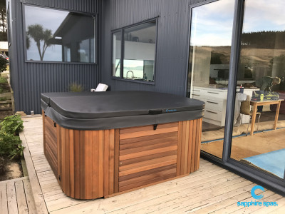 Handcrafted cedar cabinet is highlighted by the bold black colorbond cladding thanks to the team @ Spa Pools Otago NZ